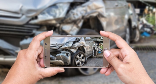 taking a picture of a car accident