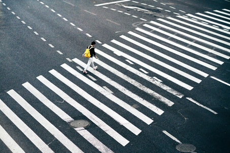 Person crossing the street in a crosswalk